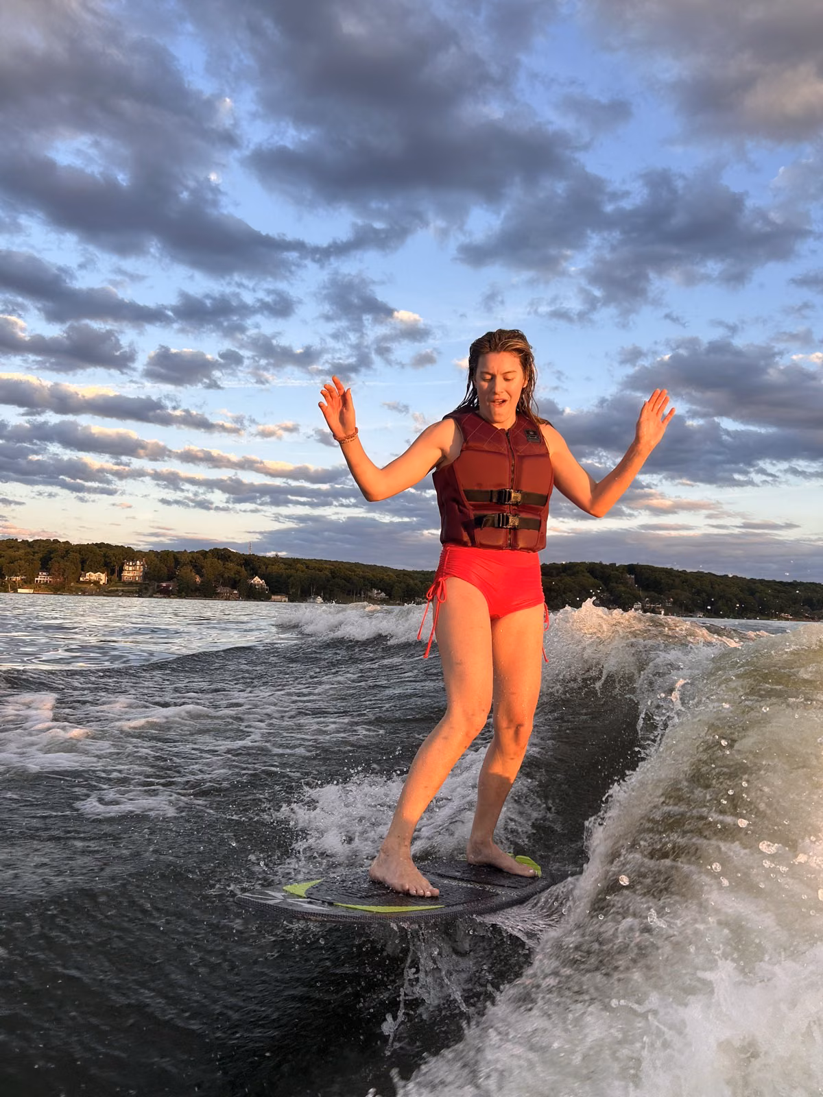 Rope-free wakesurfing at sunset on Lake Hopatcong